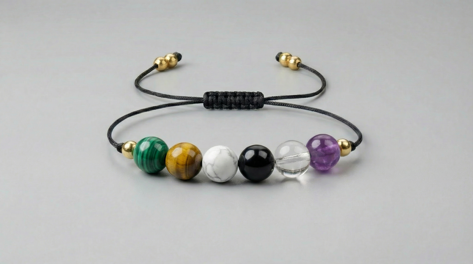 Six-gemstone pain relief support bracelet with Malachite, Amber, Dendritic Agate, Obsidian, Clear Quartz and Amethyst on black adjustable cord