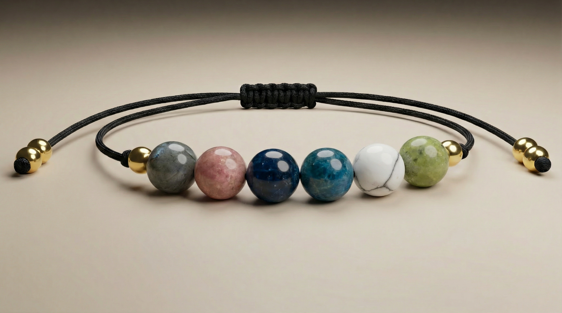 Six-gemstone body confidence and slimming support bracelet with Jade, Magnesite, Apatite, Kyanite, Strawberry Quartz and Black Labradorite on black adjustable cord
